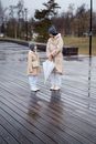 A Mother and Daughter Outside on a Rainy Day