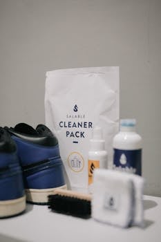 A comprehensive sneaker cleaning kit featuring a brush, cloth, and cleaning products for shoe care.