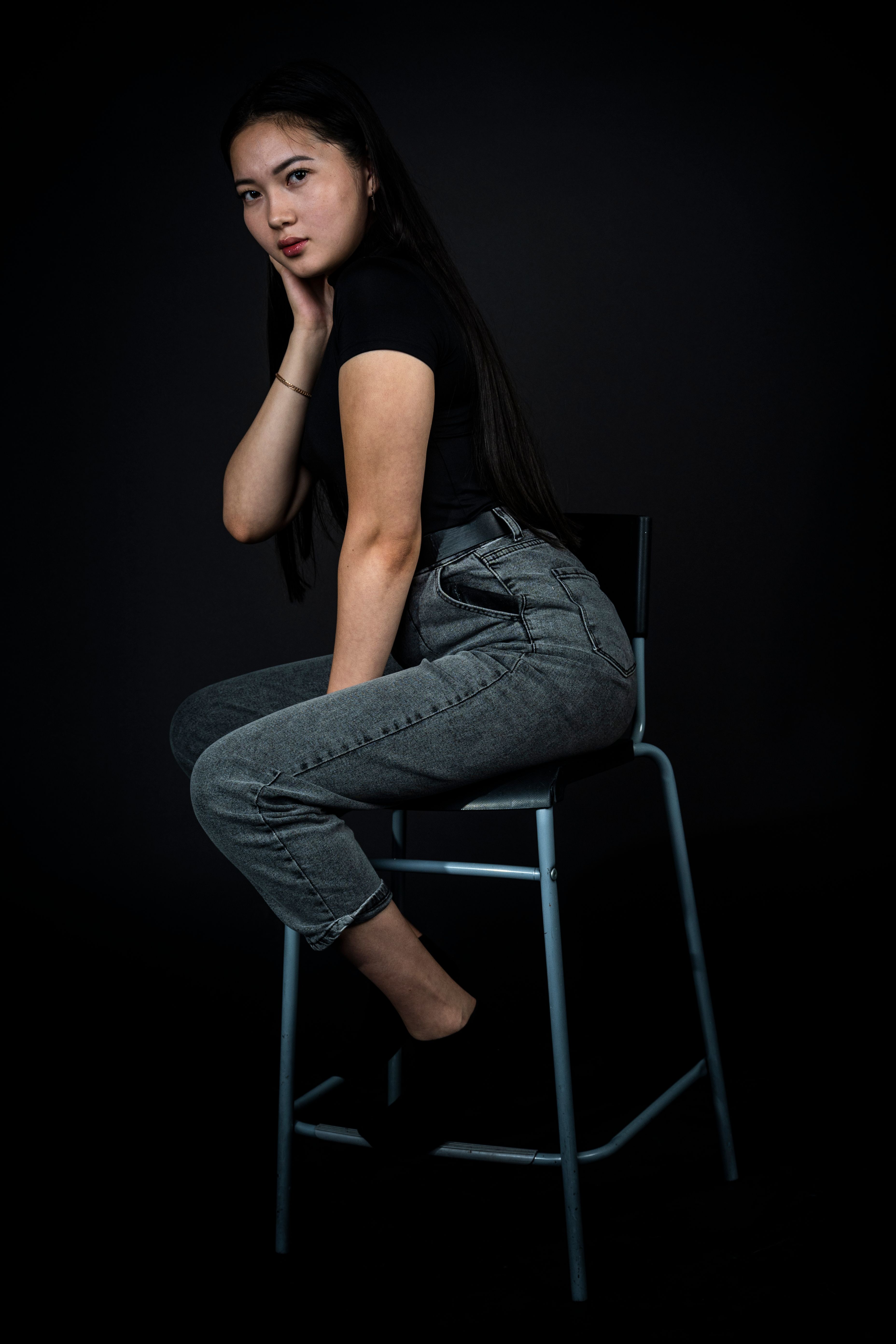 A Woman in Black Shirt and Denim Jeans Sitting on a Steel Chair · Free ...