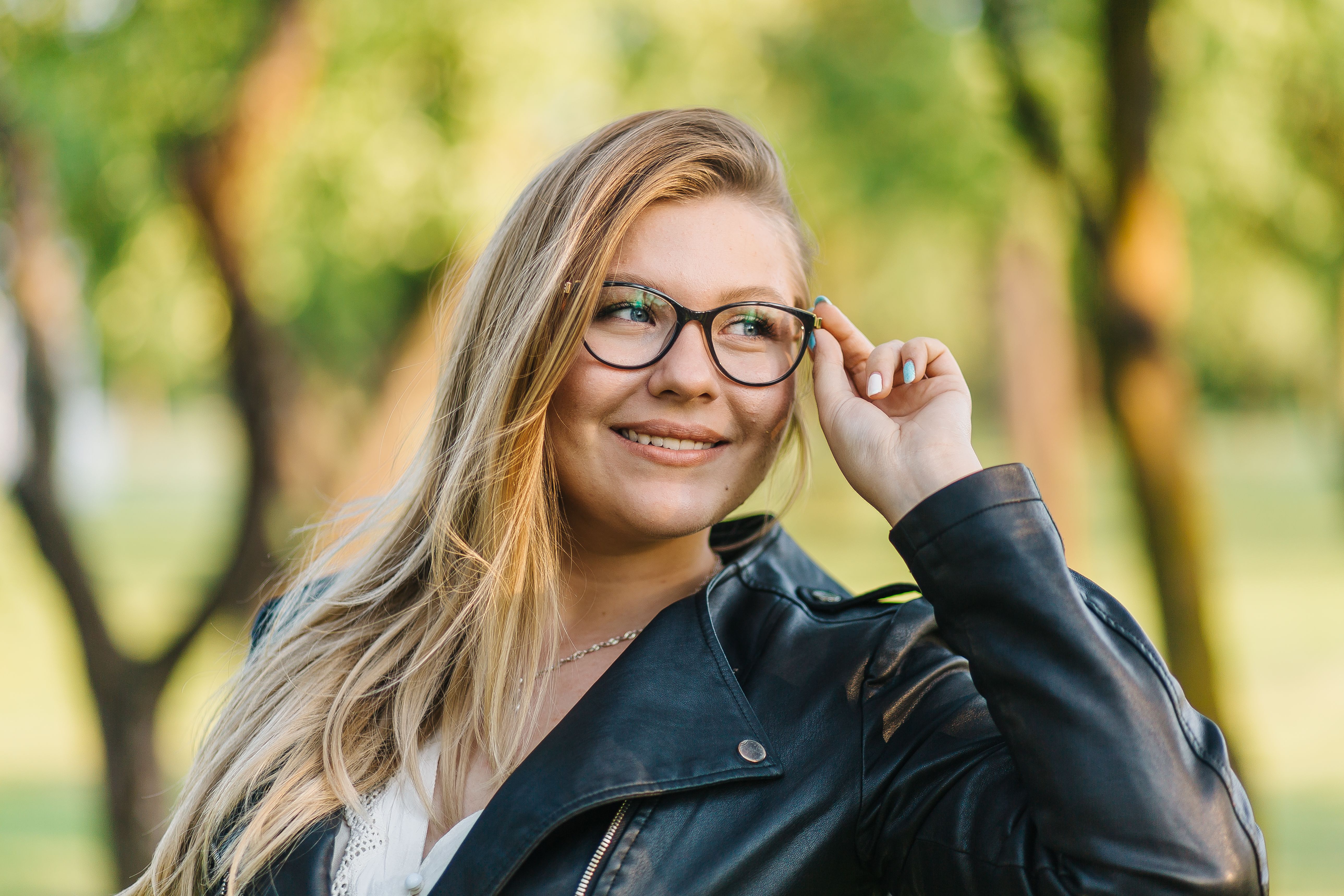 A Woman in Black Leather Jacket Wearing Eyeglasses · Free Stock Photo