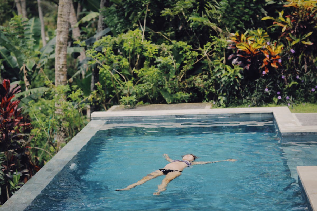 A Woman Floating in a Swimming Pool