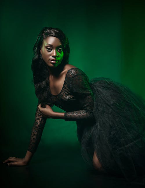 Woman Wearing Black Lace Long-sleeved Scoop-neck Gown Posing for a Photo