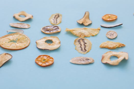 A vibrant selection of dried fruit slices on a blue background, perfect for food photography.