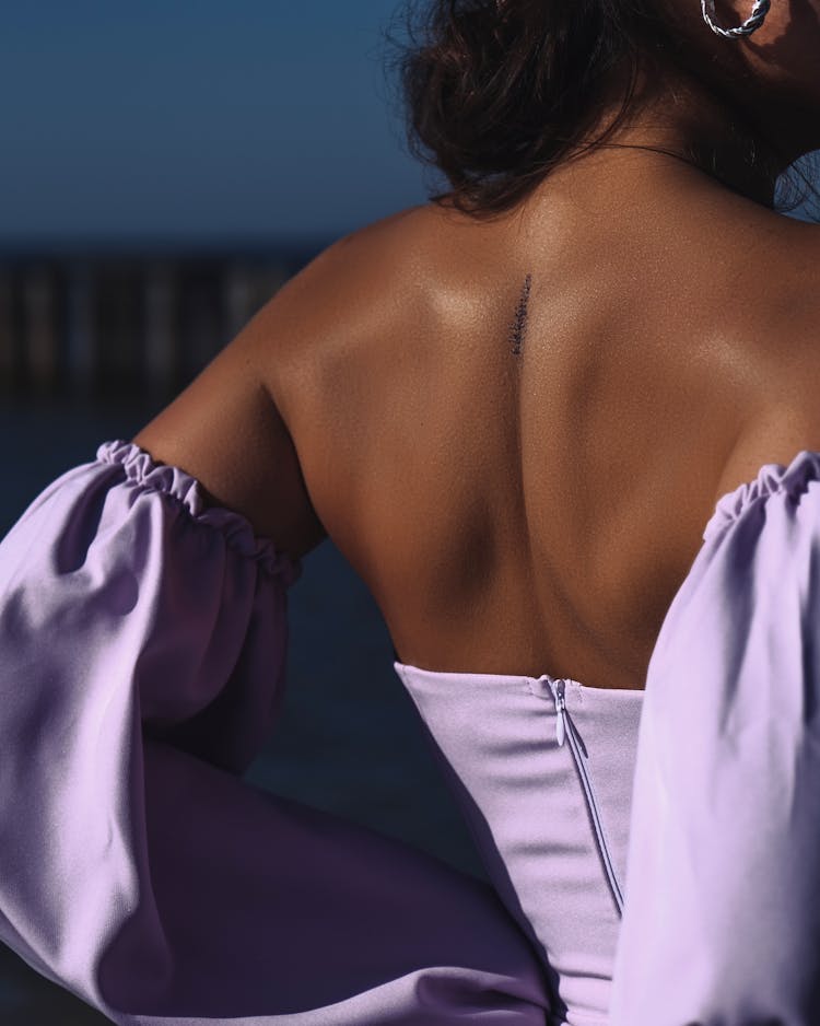 Back Of Woman In Purple Clothes