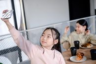 Girl in Pink Long Sleeve Shirt Sitting on Chair