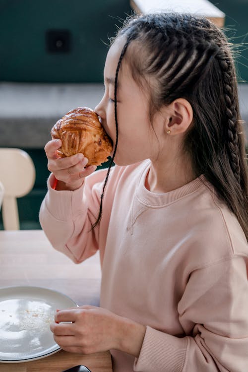 A Girl Eating a Muffin 