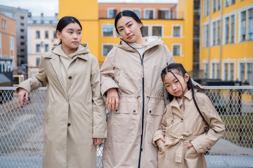 Free Shallow Focus of a Family Wearing Their Beige Coats Stock Photo