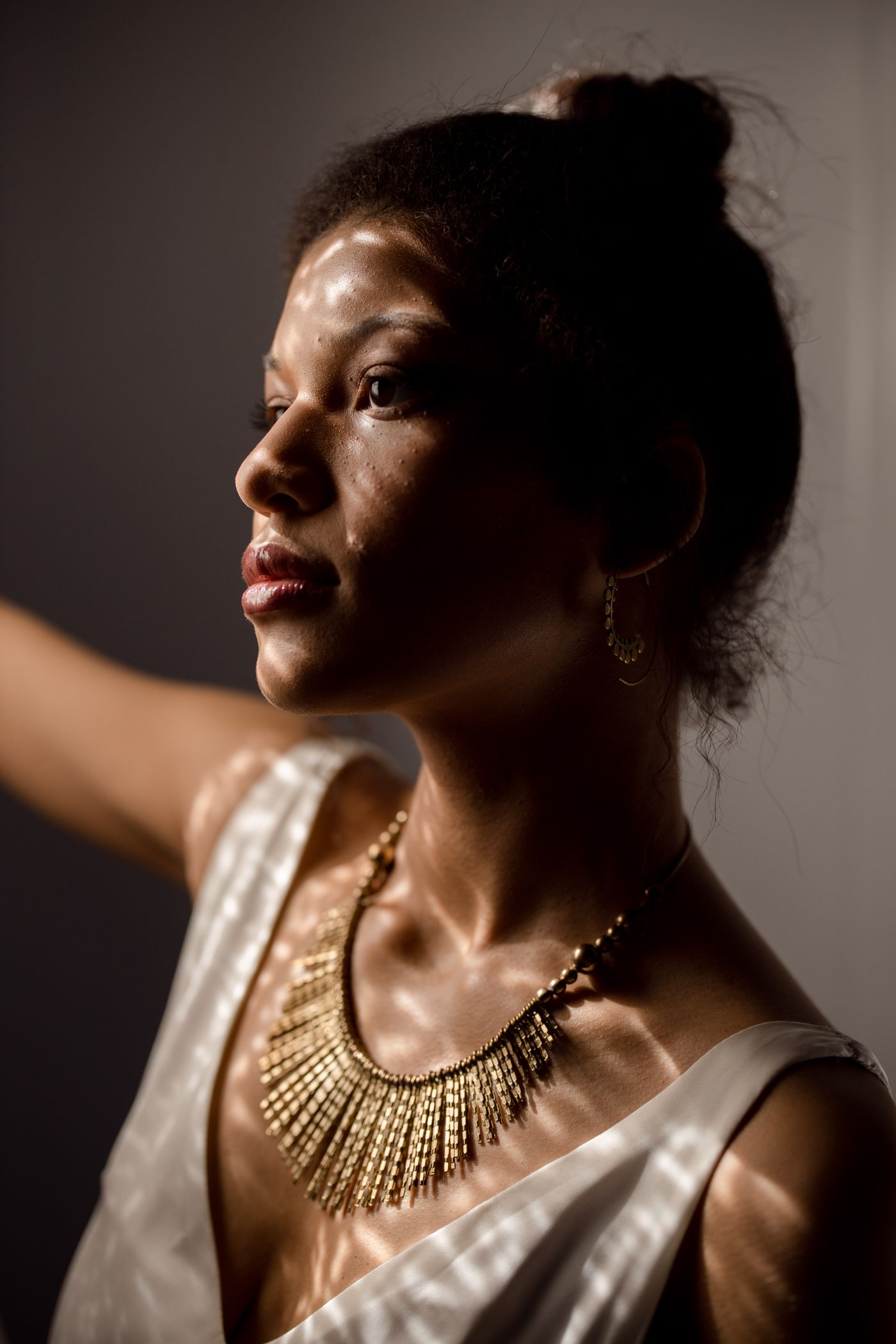 Woman wearing fine gold jewelry by Singapore Jewelers