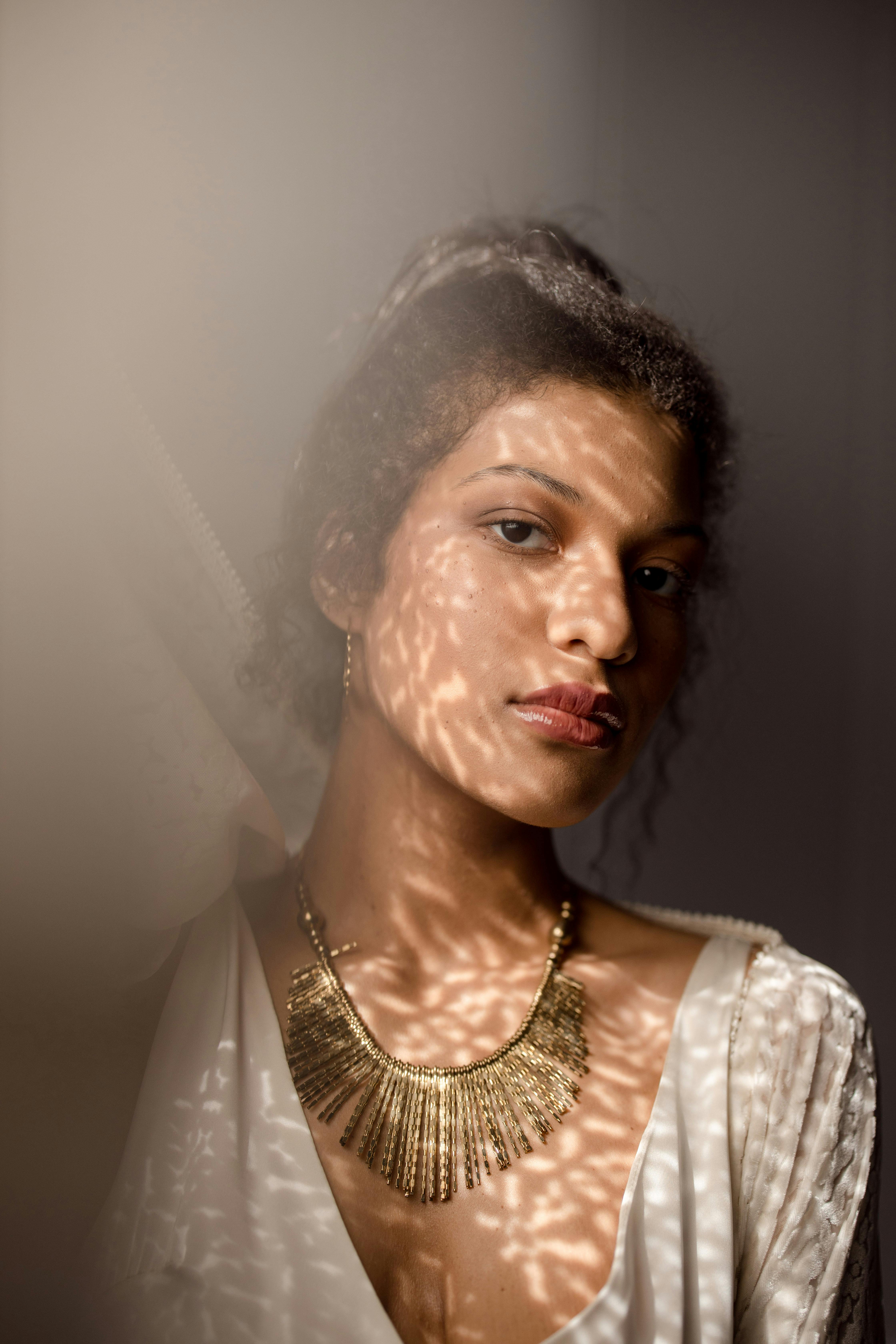 beautiful woman wearing her gold necklace