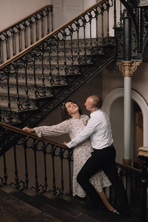 A Man and Woman Posing on the Stairs