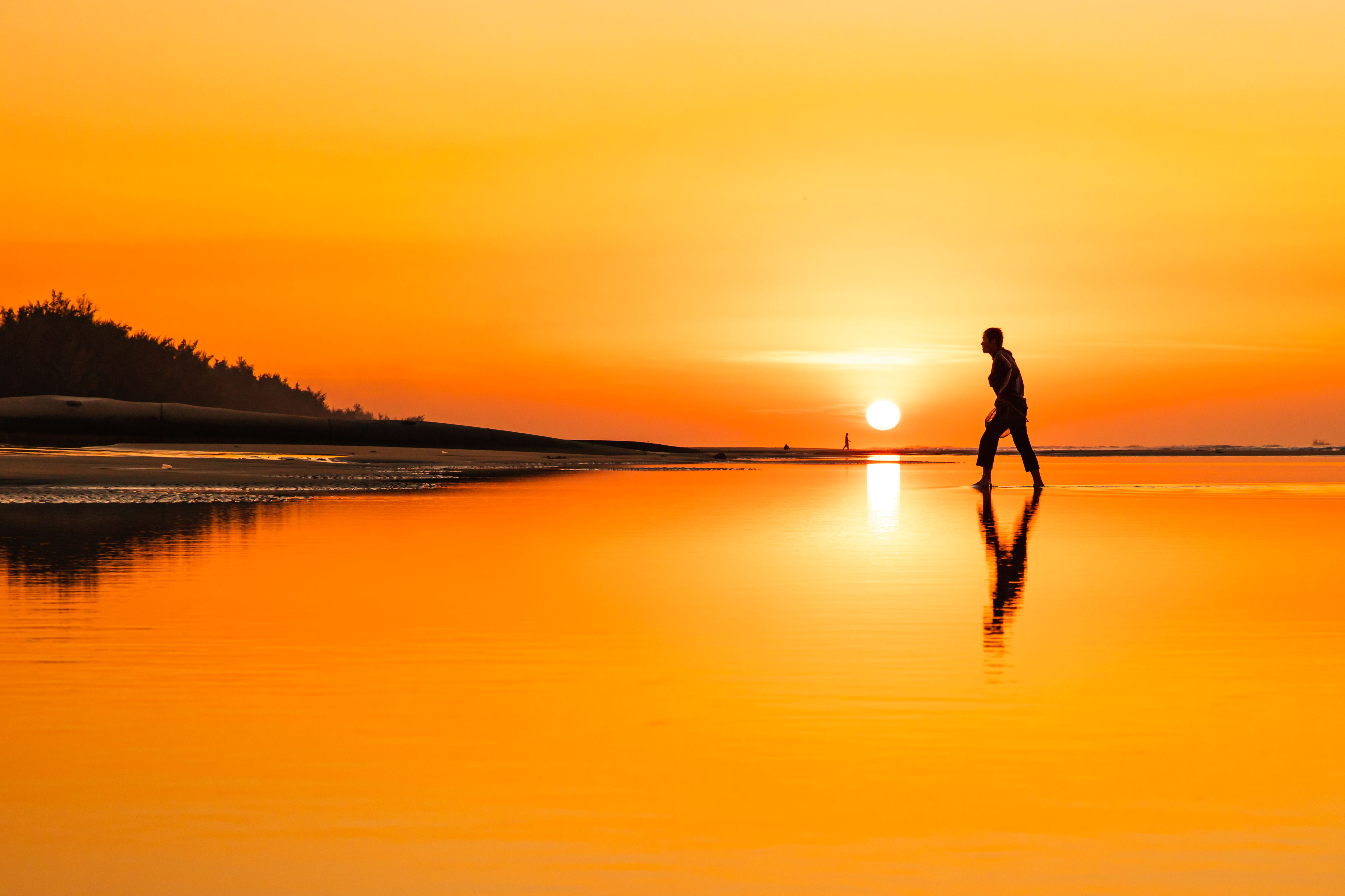 Silhouette of a Man Walking on a Water during Sunset · Free Stock Photo