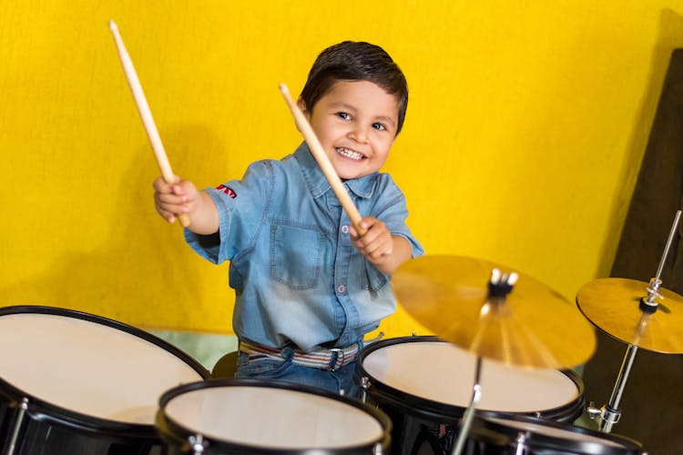 Little Boy Playing On Drums