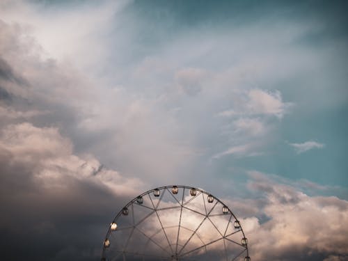 Ferris Wheel on Sunset Clouds Background