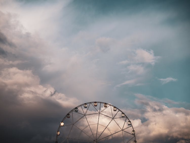 Ferris Wheel On Sunset Clouds Background