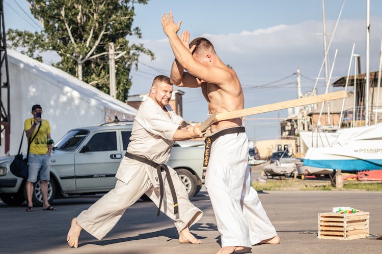 Men In Uniform Fighting Outdoors