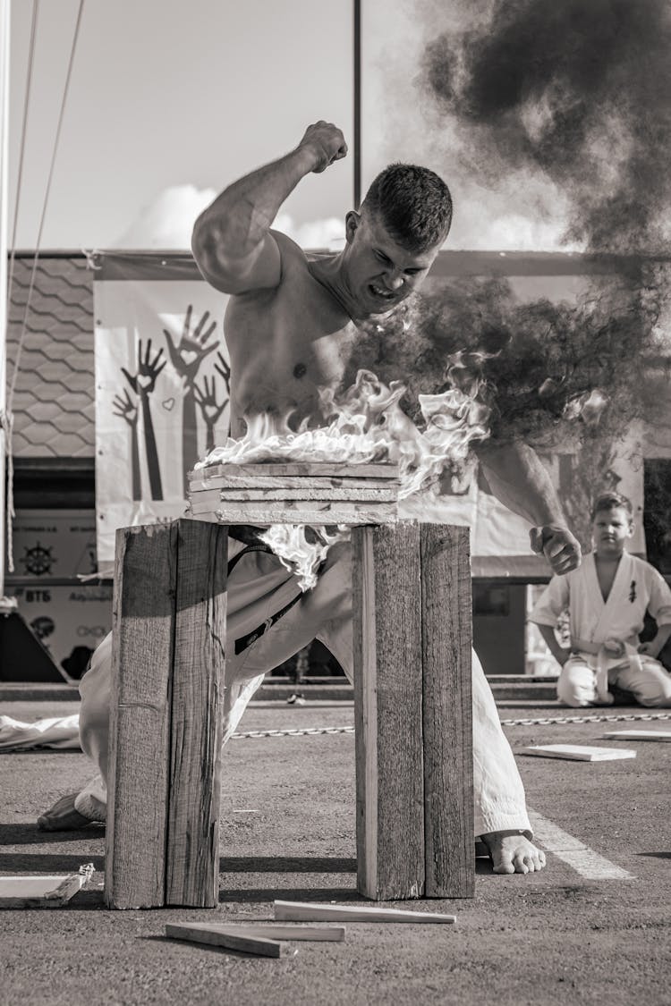 Strongman Breaking Burning Bricks With Hand