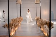 A Model Wearing a White Dress Walking on the Runway