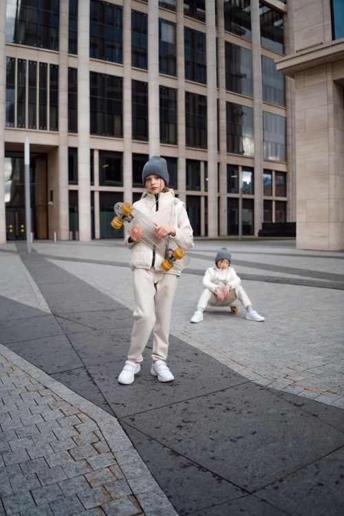 Free Two teenagers skateboarding on a modern urban street, enjoying a day out. Stock Photo
