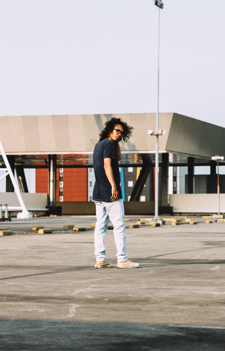 Man In Casual Wear Posing In The Parking Lot