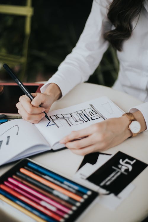 Person Writing on White Paper