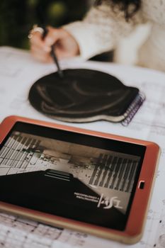 Close-up of an architect sketching on a digital tablet with stylus.
