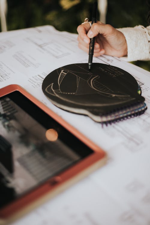 Free Architect drawing on a Black Paper in Tilt Shift Lens Stock Photo