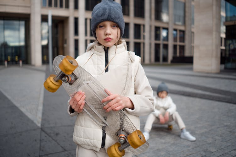 A Girl Holding A Skateboard