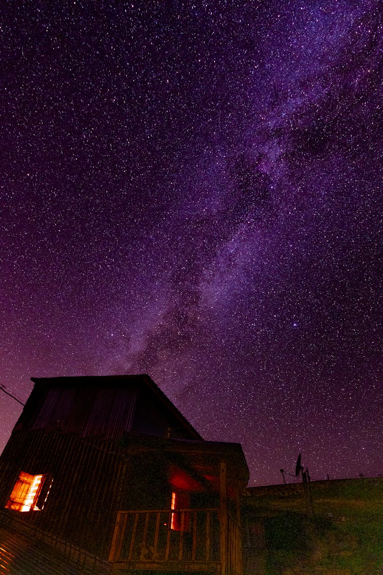 Starry Night Sky Above House In Nature