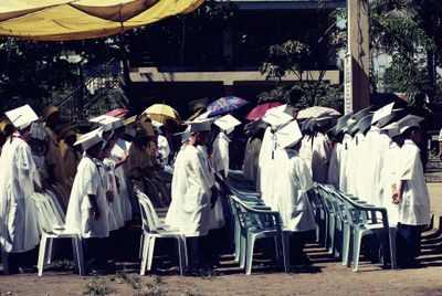 Group of children in academic gowns celebrating graduation