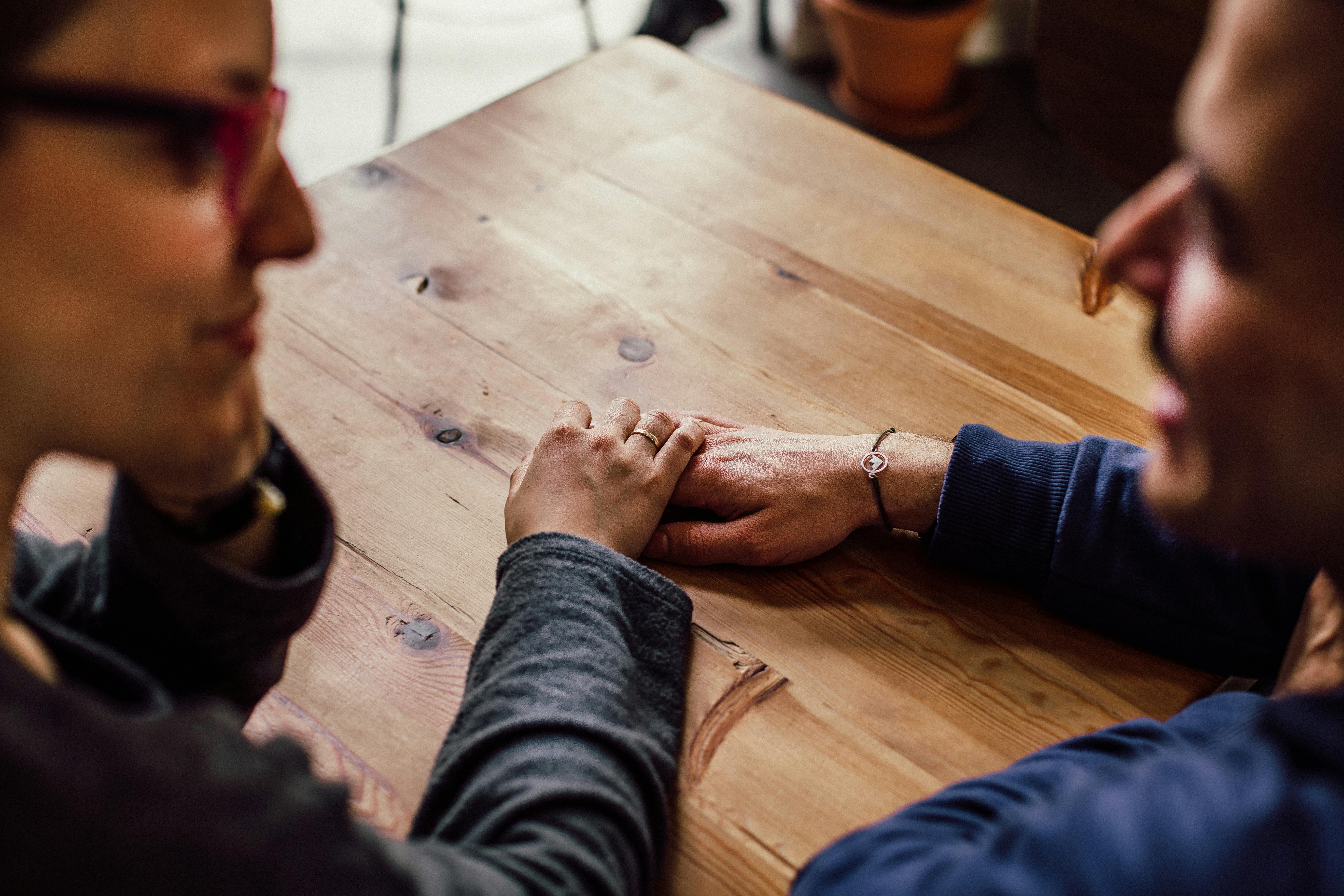 Free Man and Woman Sitting Together in Front of Table Stock Photo