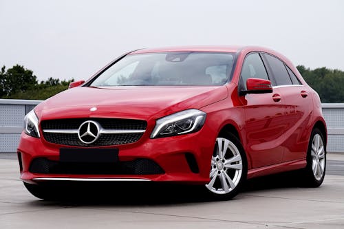 Red Mercedes Benz Car Parked on Concrete Ground