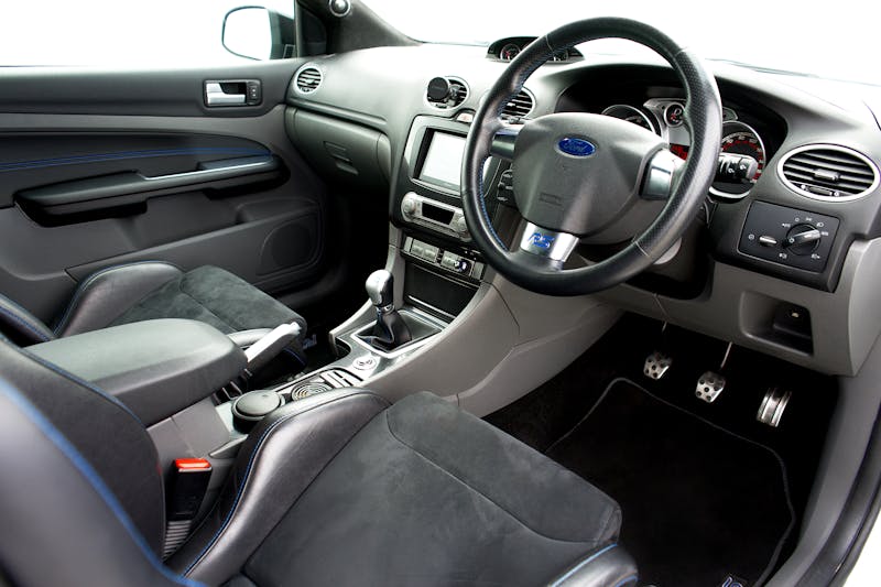 Learner driver changing gear during a driving lesson in a manual car.