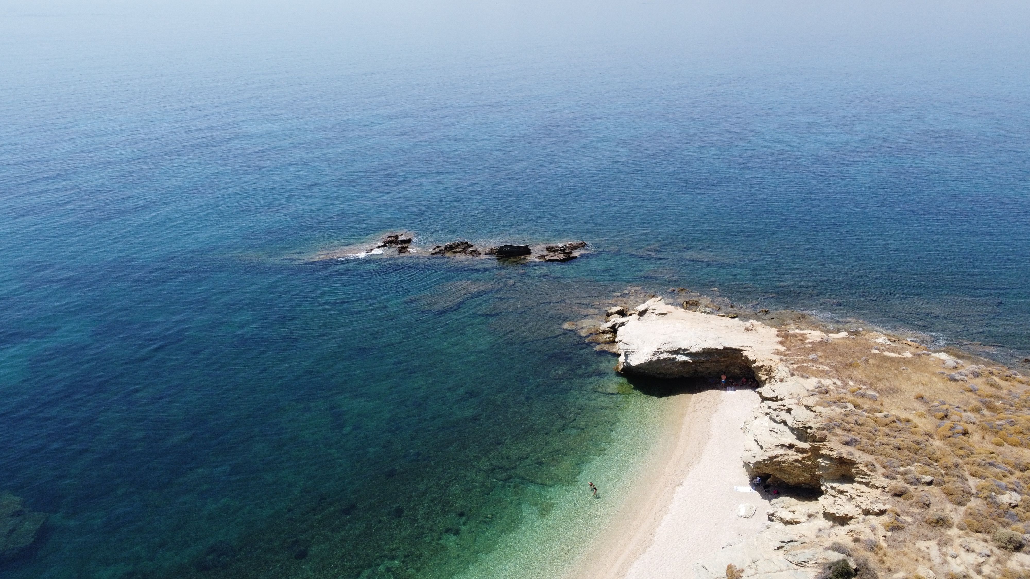 Aerial view of clear water and a rugged coastline on Evia