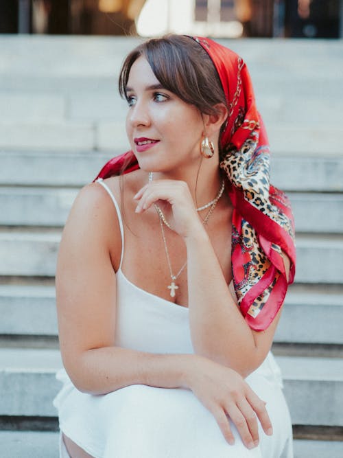 Woman in a White Dress Wearing a Red Headscarf