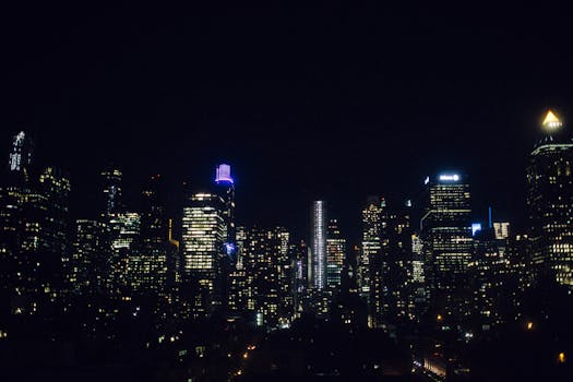 Iconic New York City skyline lit up at night showcasing skyscrapers and city lights.