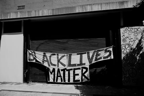 Grayscale Photo of a Graffiti on a Wall