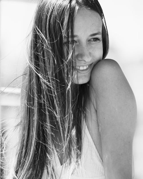 Grayscale Photo of Woman in White Tank Top