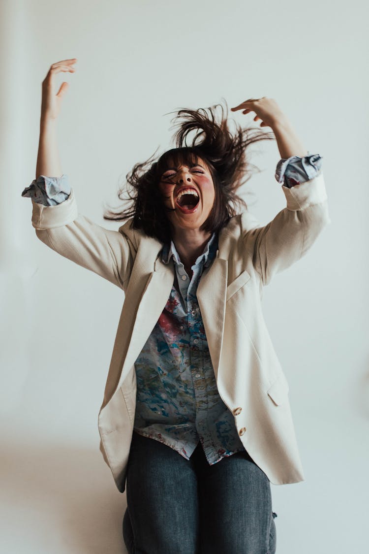 Sassy Woman Wearing Beige Suit On White Background