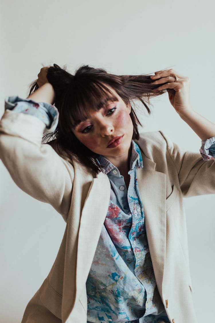 Sassy Woman Wearing Beige Suit On White Background