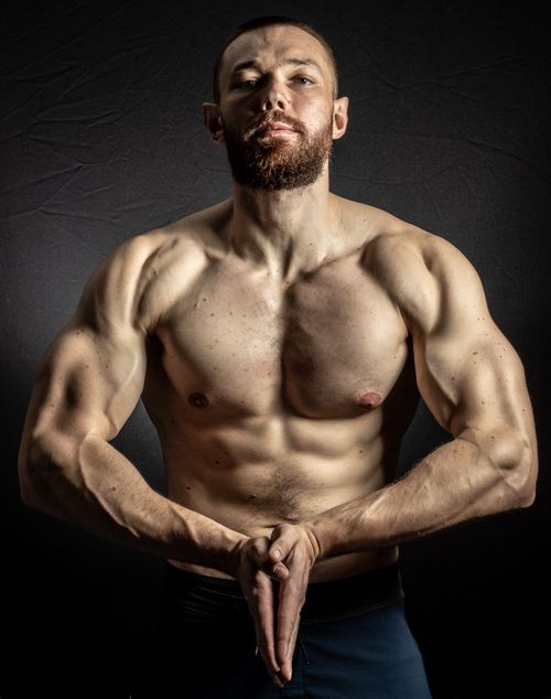Free Powerful male bodybuilder demonstrating his muscular physique indoors. Stock Photo