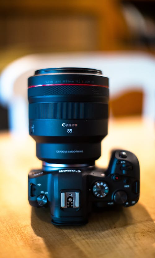 Black Canon Dslr Camera on Brown Wooden Table