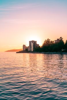 Capture of North Vancouver's skyline at sunset, featuring tranquil lakeshore views and vibrant colors.