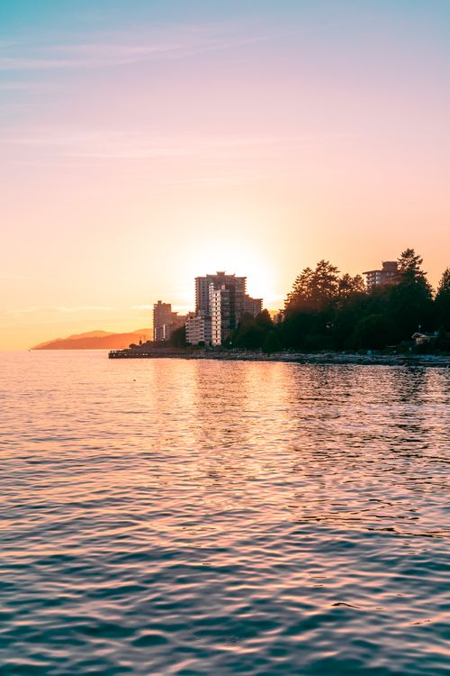 Free Capture of North Vancouver's skyline at sunset, featuring tranquil lakeshore views and vibrant colors. Stock Photo