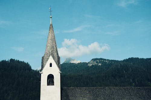 Gray and White Steeple Under the Blue Sky