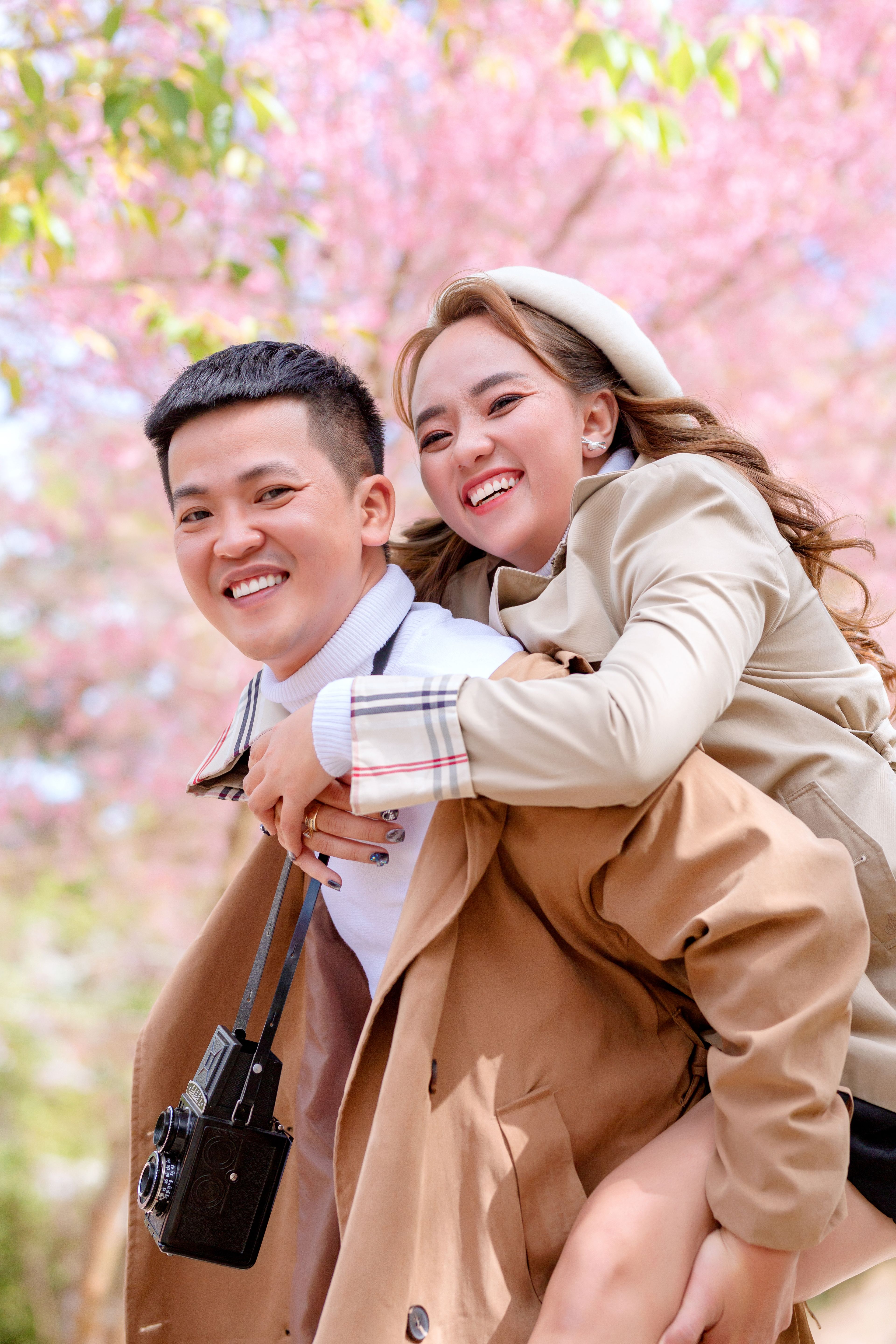 Man in Brown Coat Hugging Woman in Brown Coat · Free Stock Photo