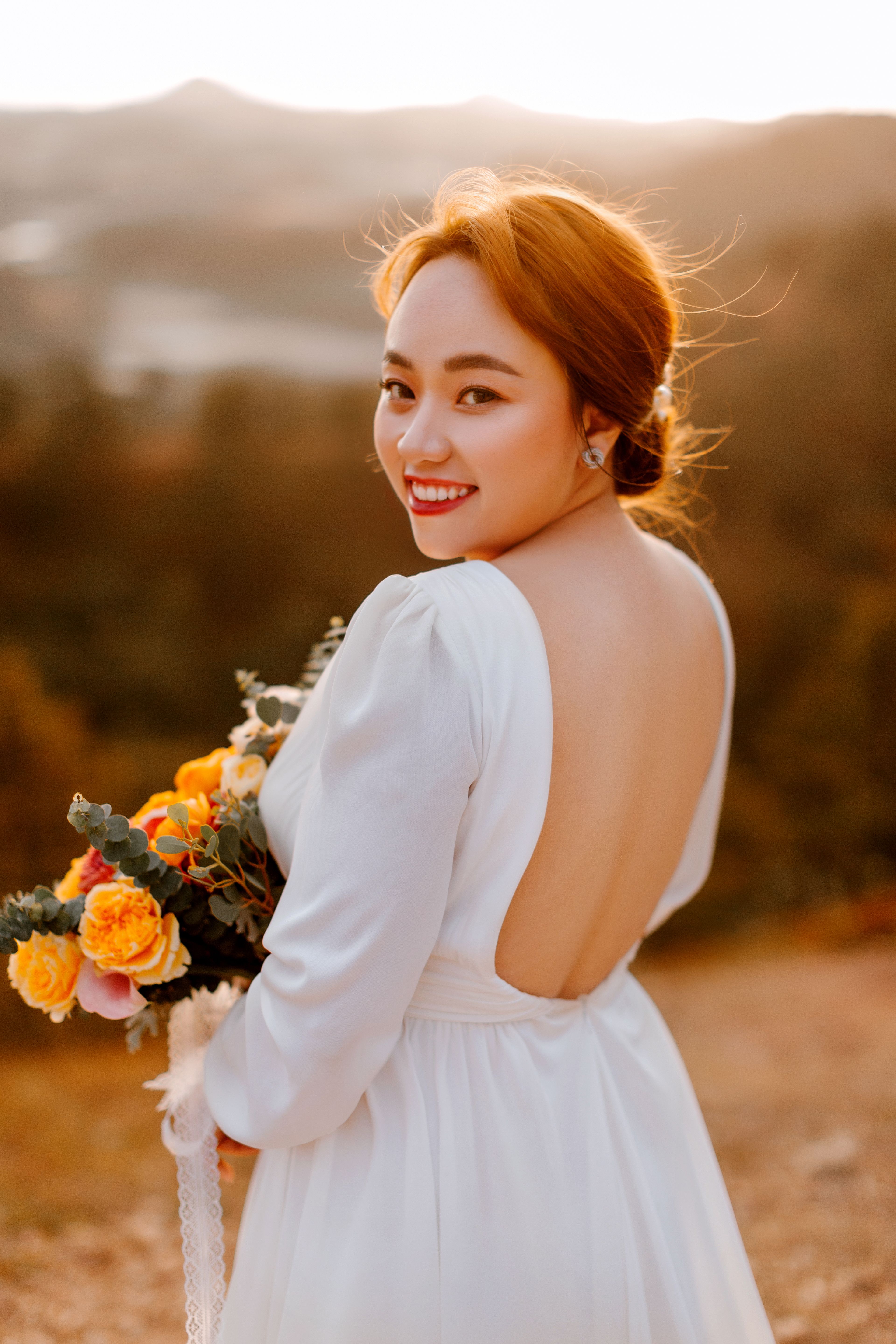 Woman in White Dress Holding Bouquet of Flowers · Free Stock Photo