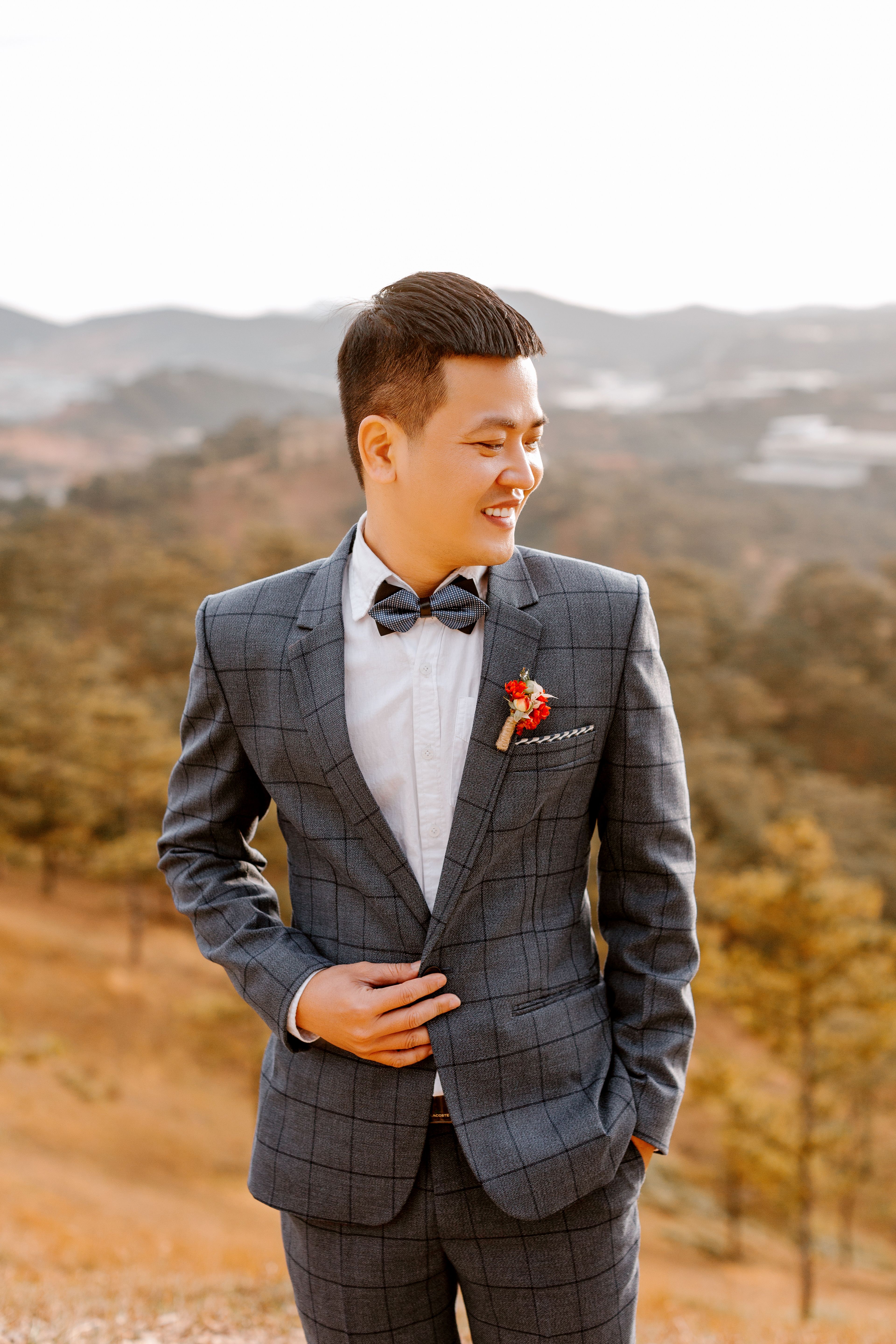 Man in Black and White Striped Suit Standing on Brown Field · Free