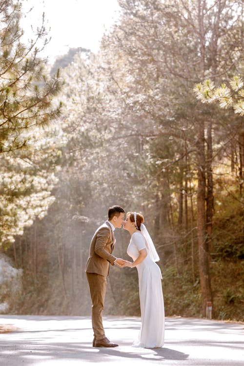 Free Man and Woman Kissing in the Woods Stock Photo