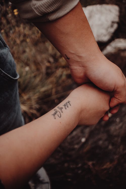 Two People with Tattoo on Arm and Wrist