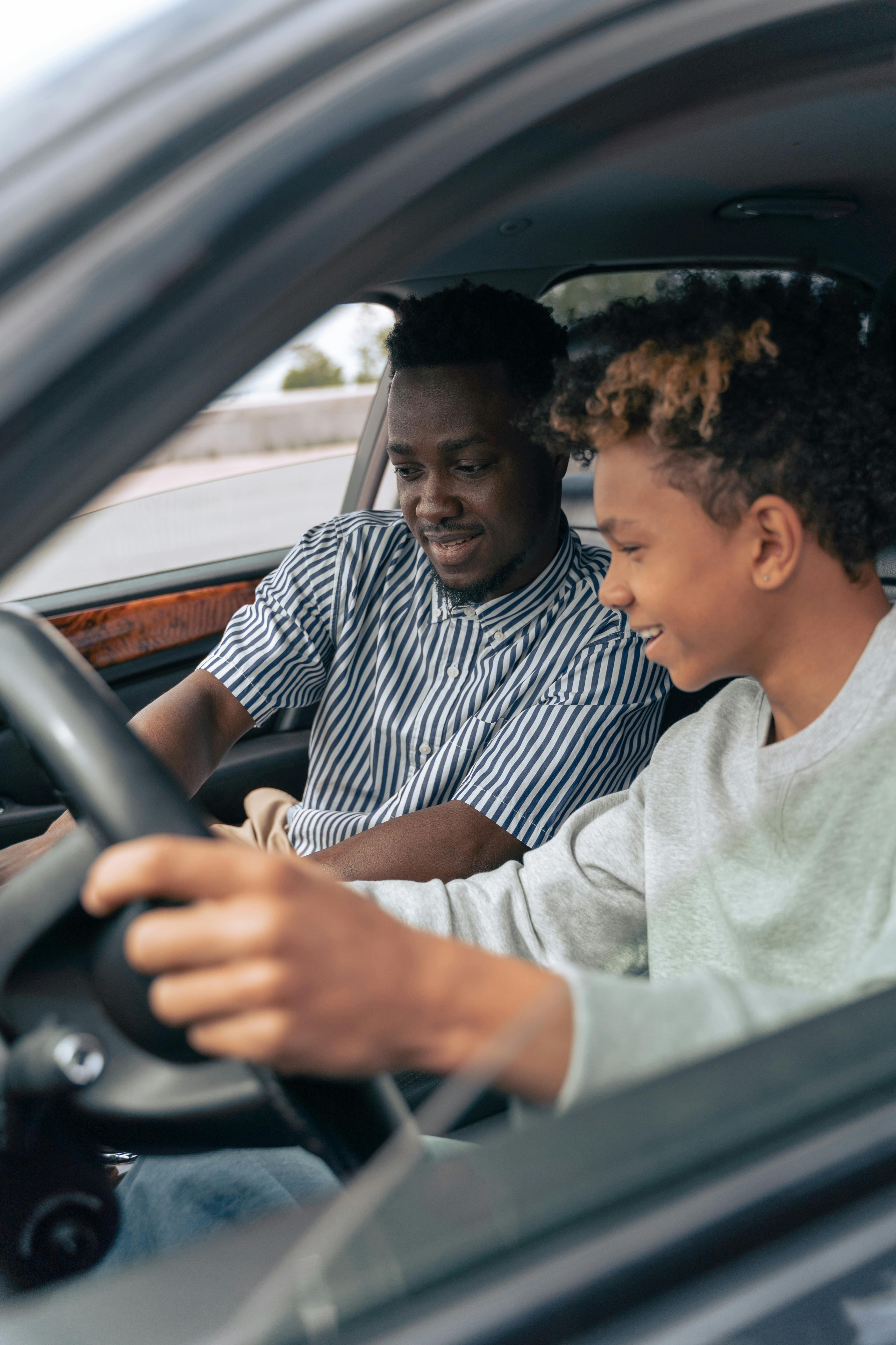 man in white and black striped dress shirt driving car